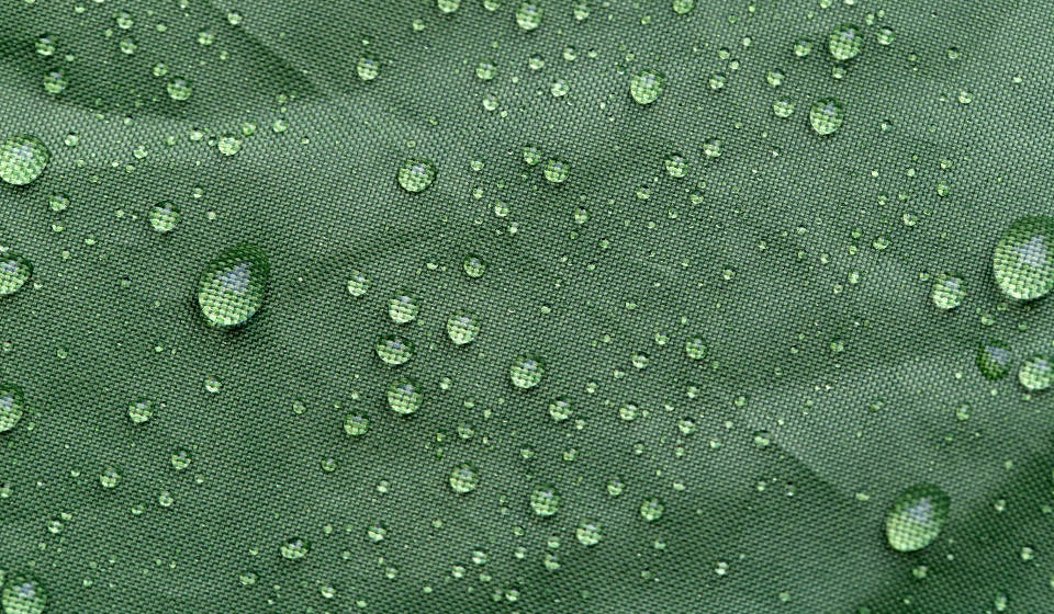 Goccioline D'acqua Su Tessuto Verde Sfondo