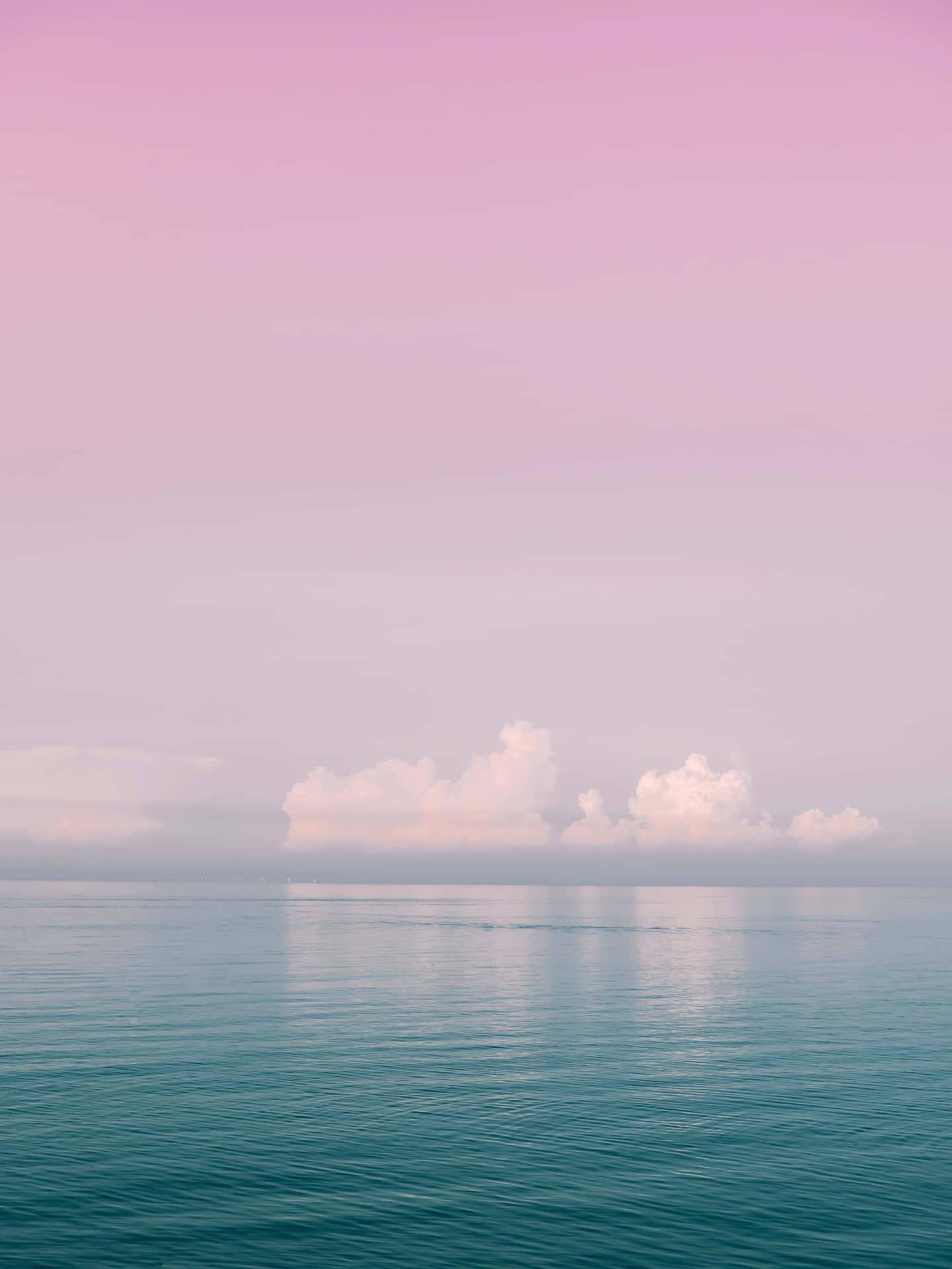 Umcéu Rosa E Azul Com Nuvens Sobre O Oceano. Papel de Parede