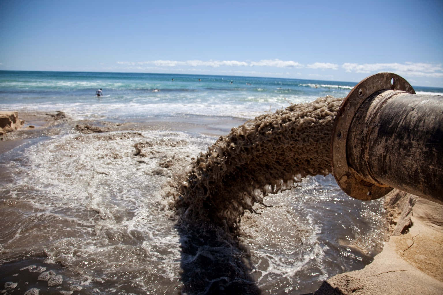 A Pipe Is Being Drained Into The Ocean