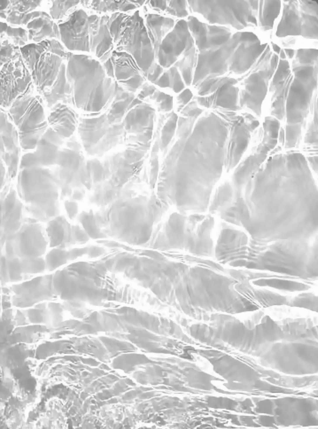 A Black And White Photo Of Water In The Pool