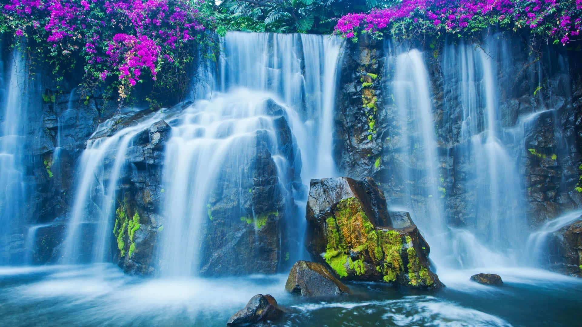 Explore the beauty of nature with this stunning picture of a majestic waterfall