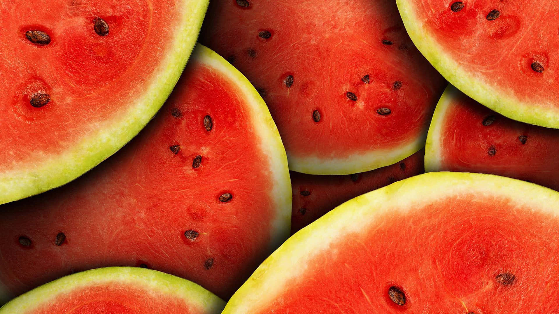 Half Sliced Watermelons In Circular Shape Background