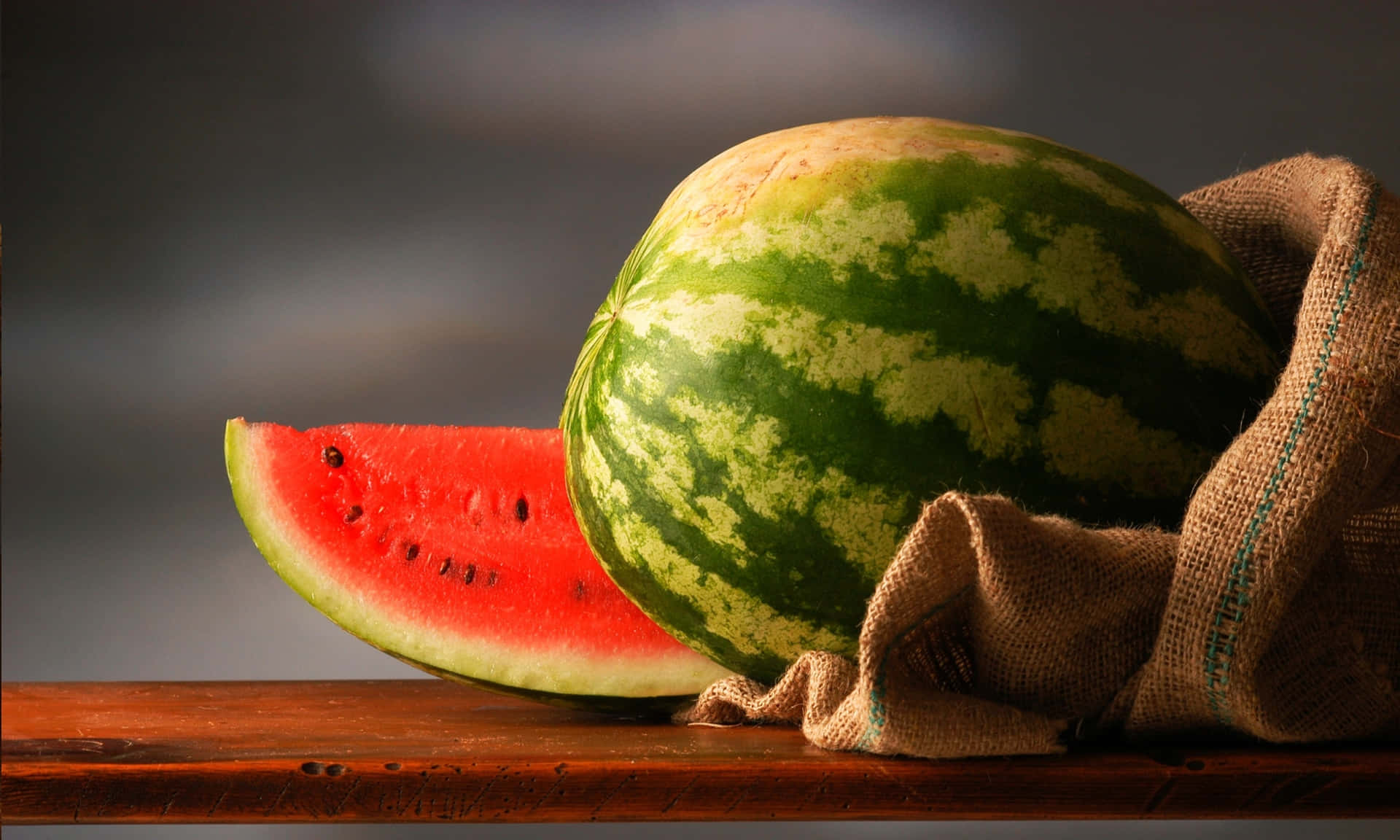 Flavorful Sliced And Unsliced Watermelon Background
