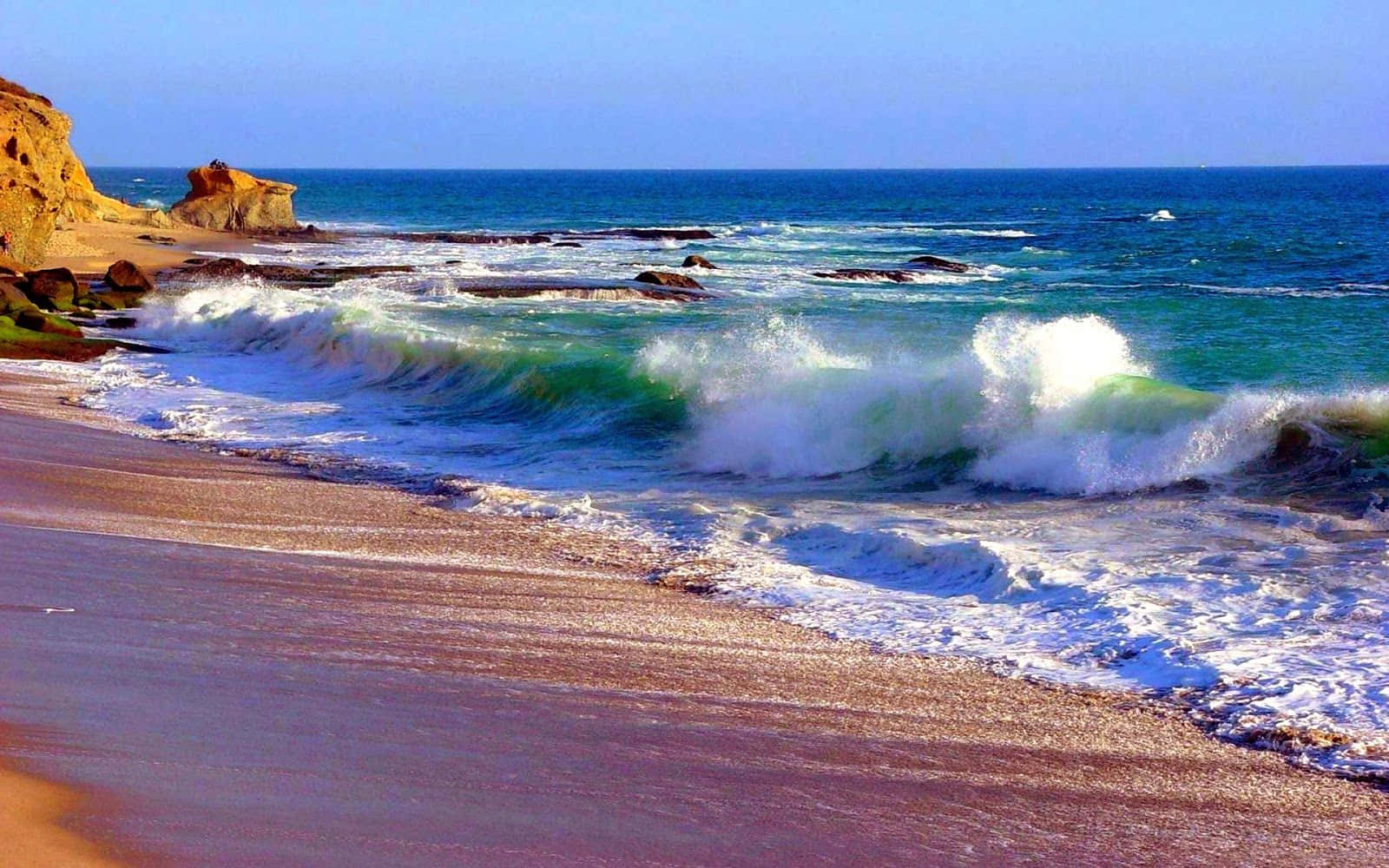 Waves Crashing on the Shore in the Sunset