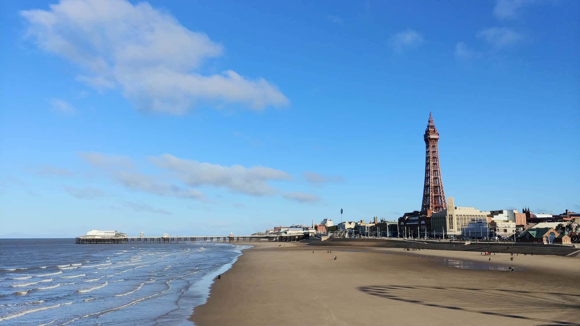 Waves Hitting Beach With Blackpool Tower In Background Wallpaper
