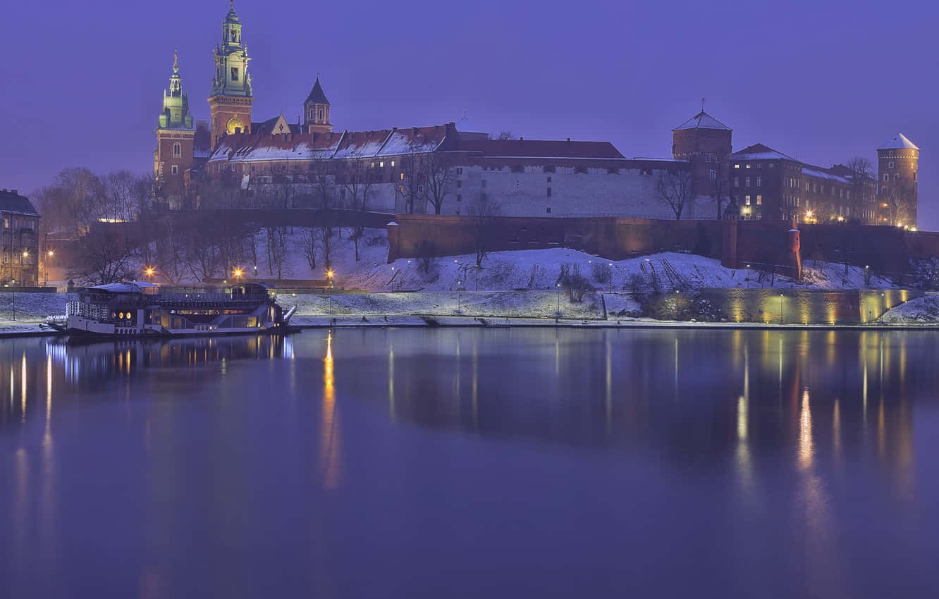 Majestic Wawel Castle on a Crisp Winter Evening Wallpaper