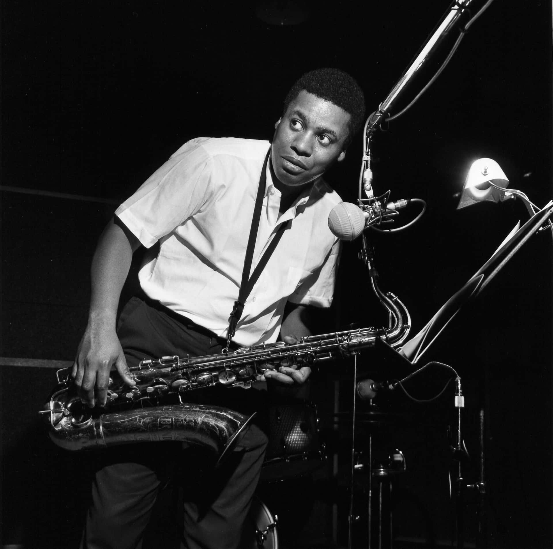 Wayne Shorter performing on stage with his saxophone. Wallpaper