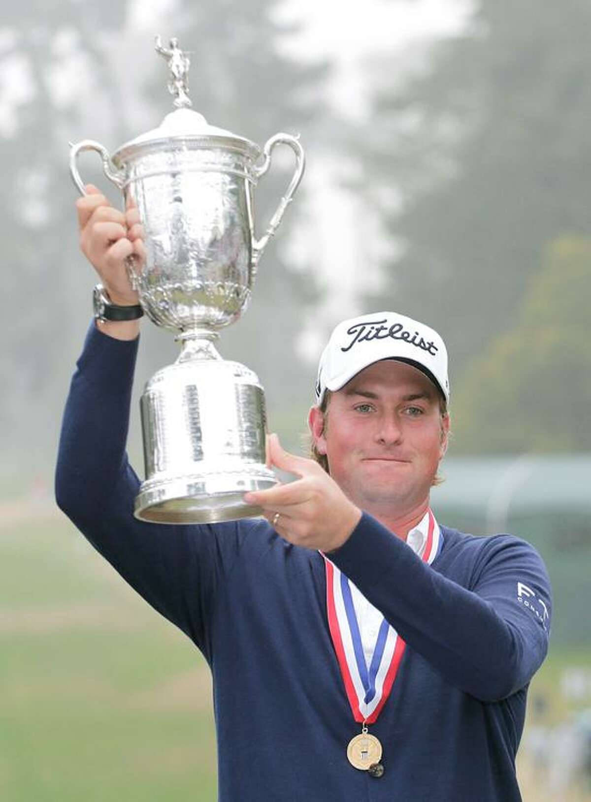 Webb Simpson Proudly Holding a Silver Trophy Wallpaper
