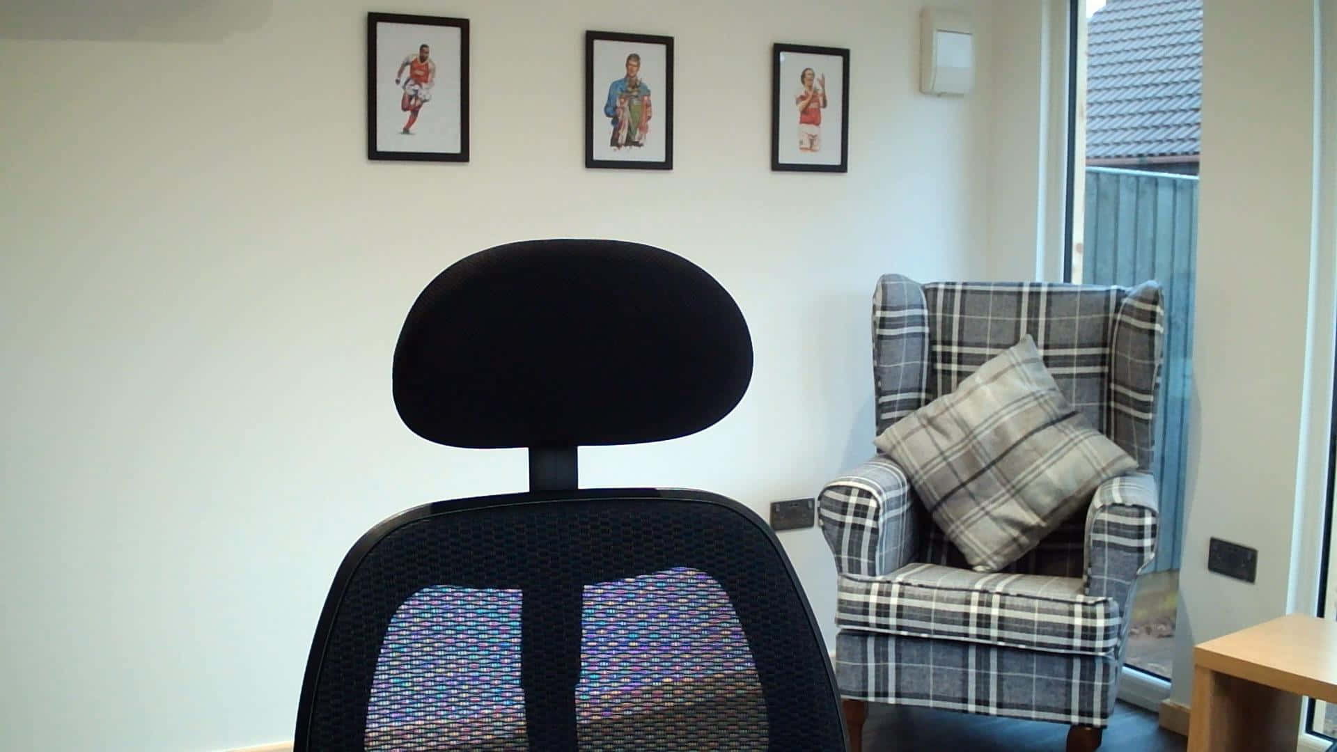 A Black Office Chair In Front Of A Window