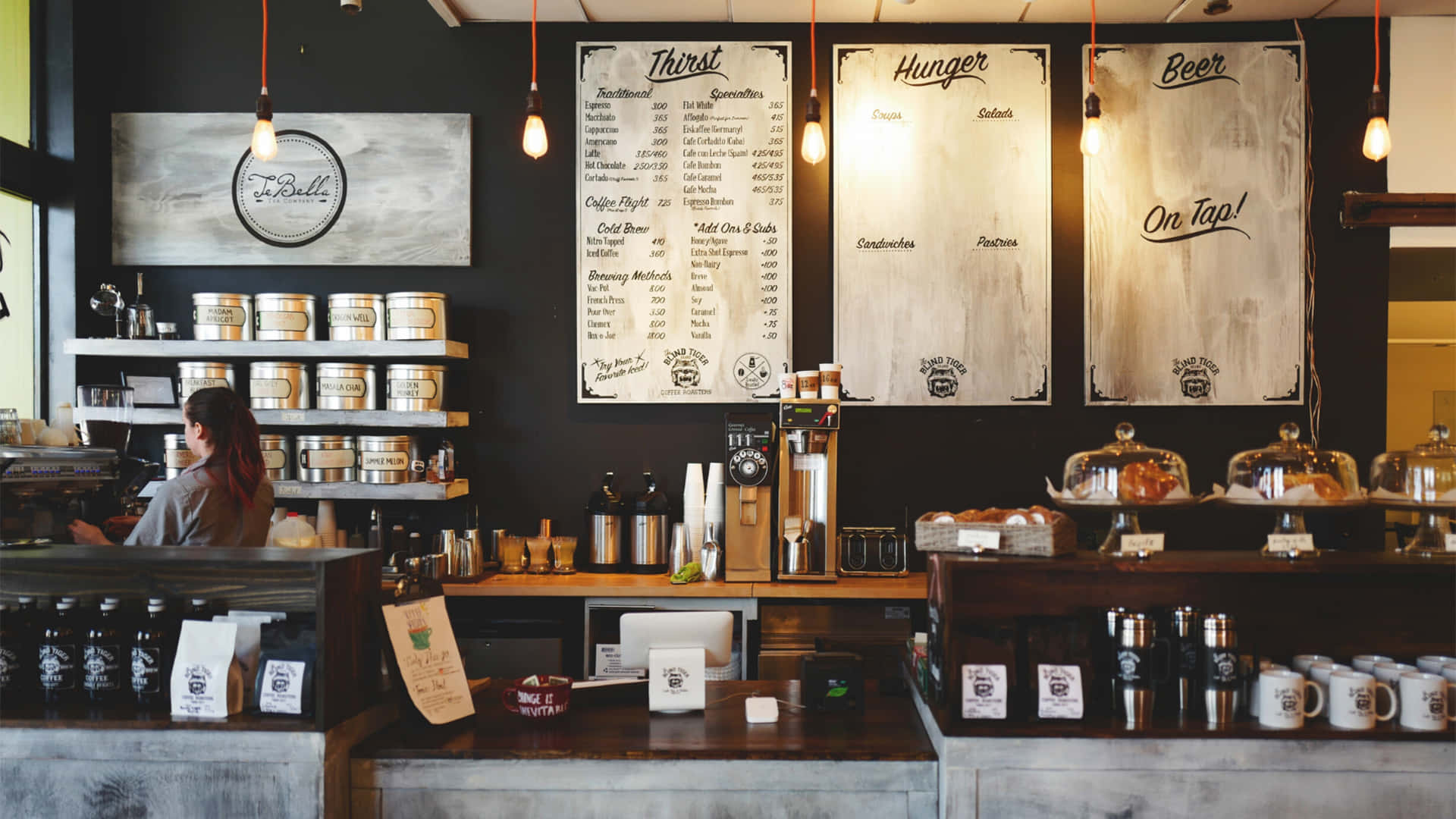 A Coffee Shop With A Counter And Shelves