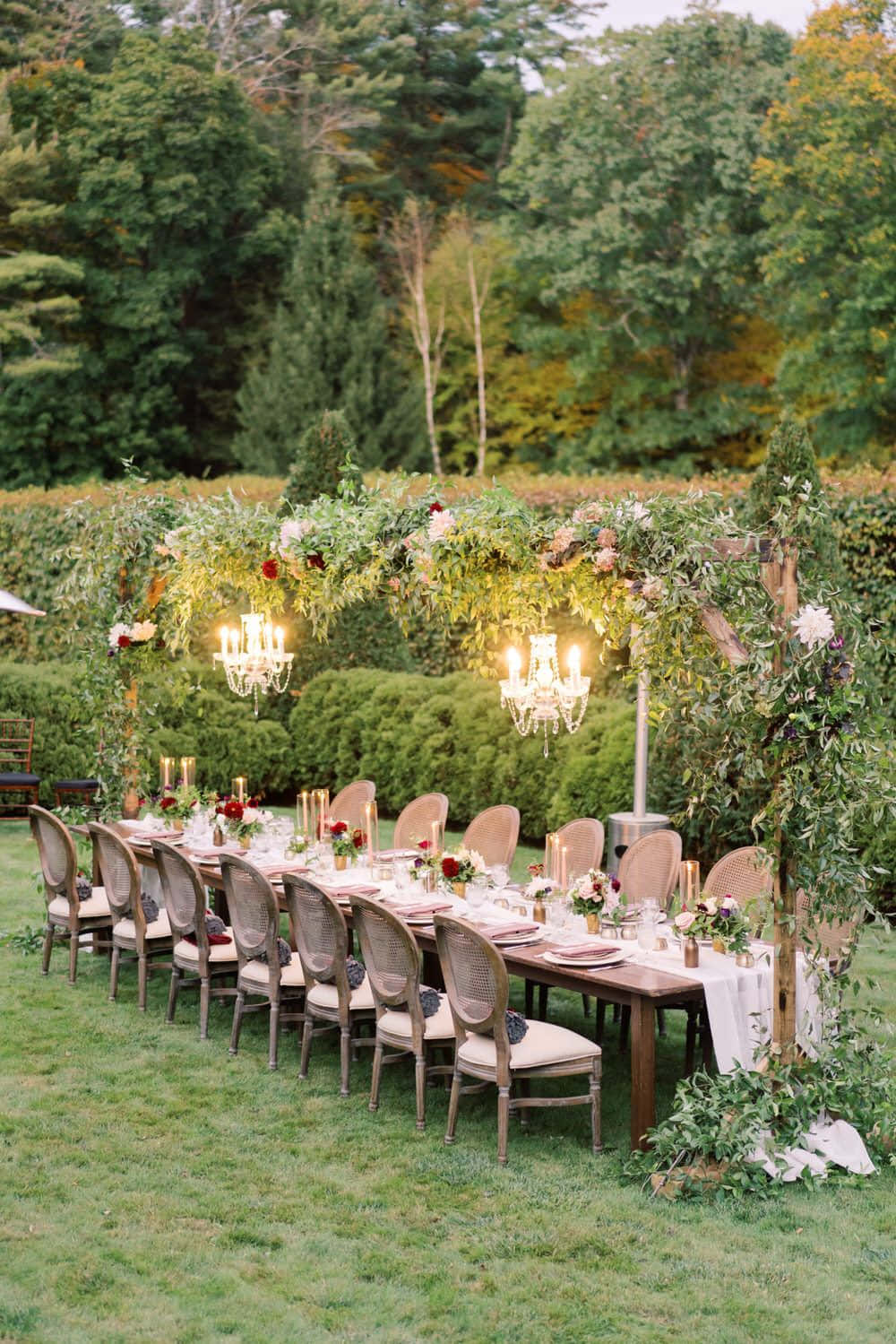 A Long Table Set Up In A Grassy Yard