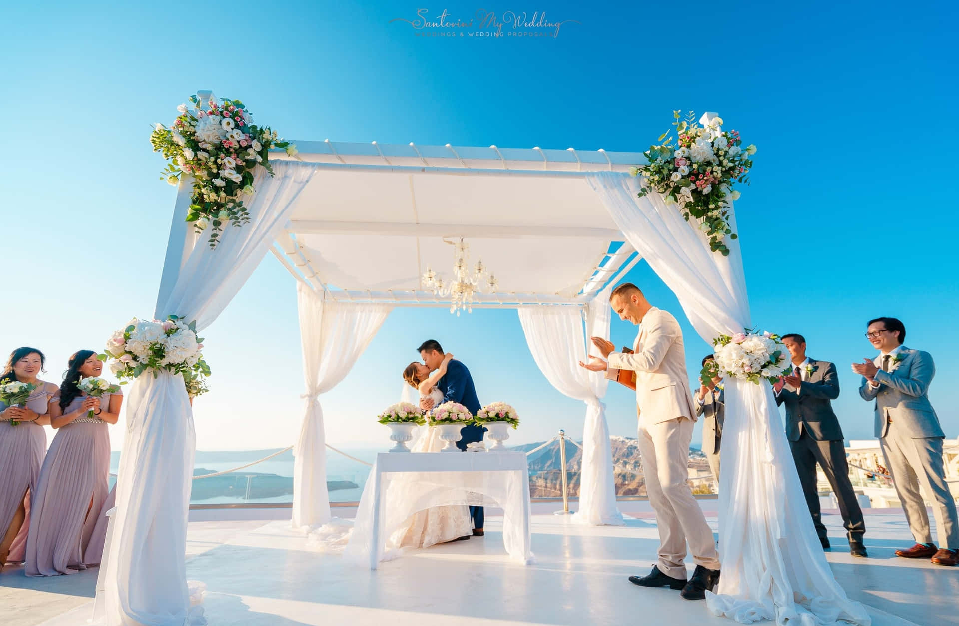 A Wedding Ceremony With A White Canopy And White Flowers