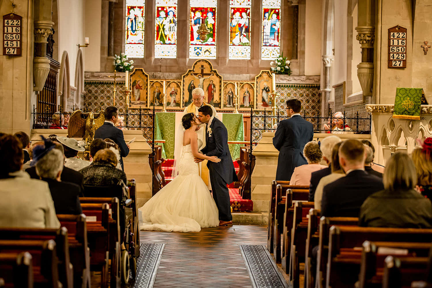 A Bride And Groom Kissing In A Church