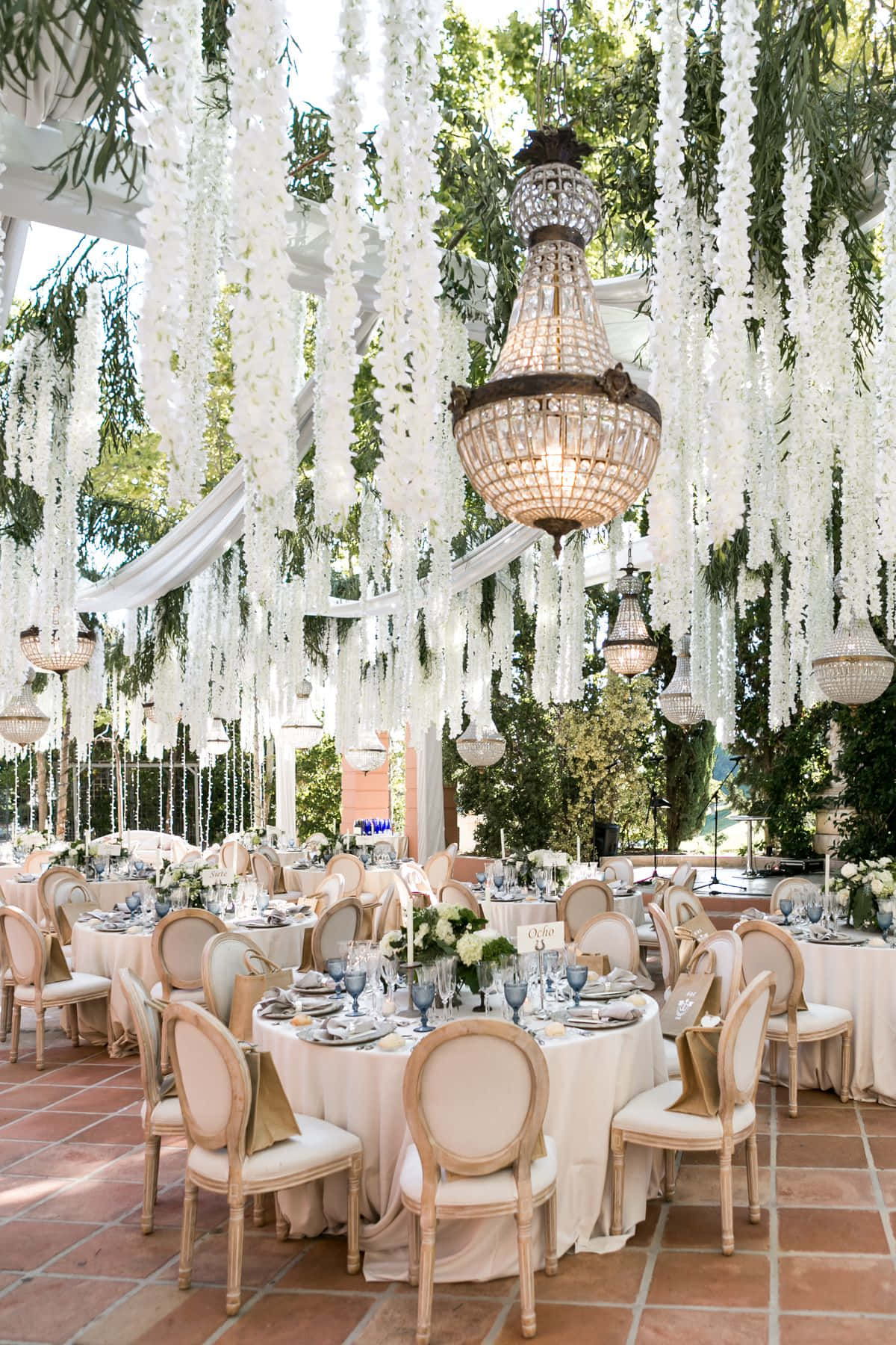 A Wedding Reception With White Tables And Chairs