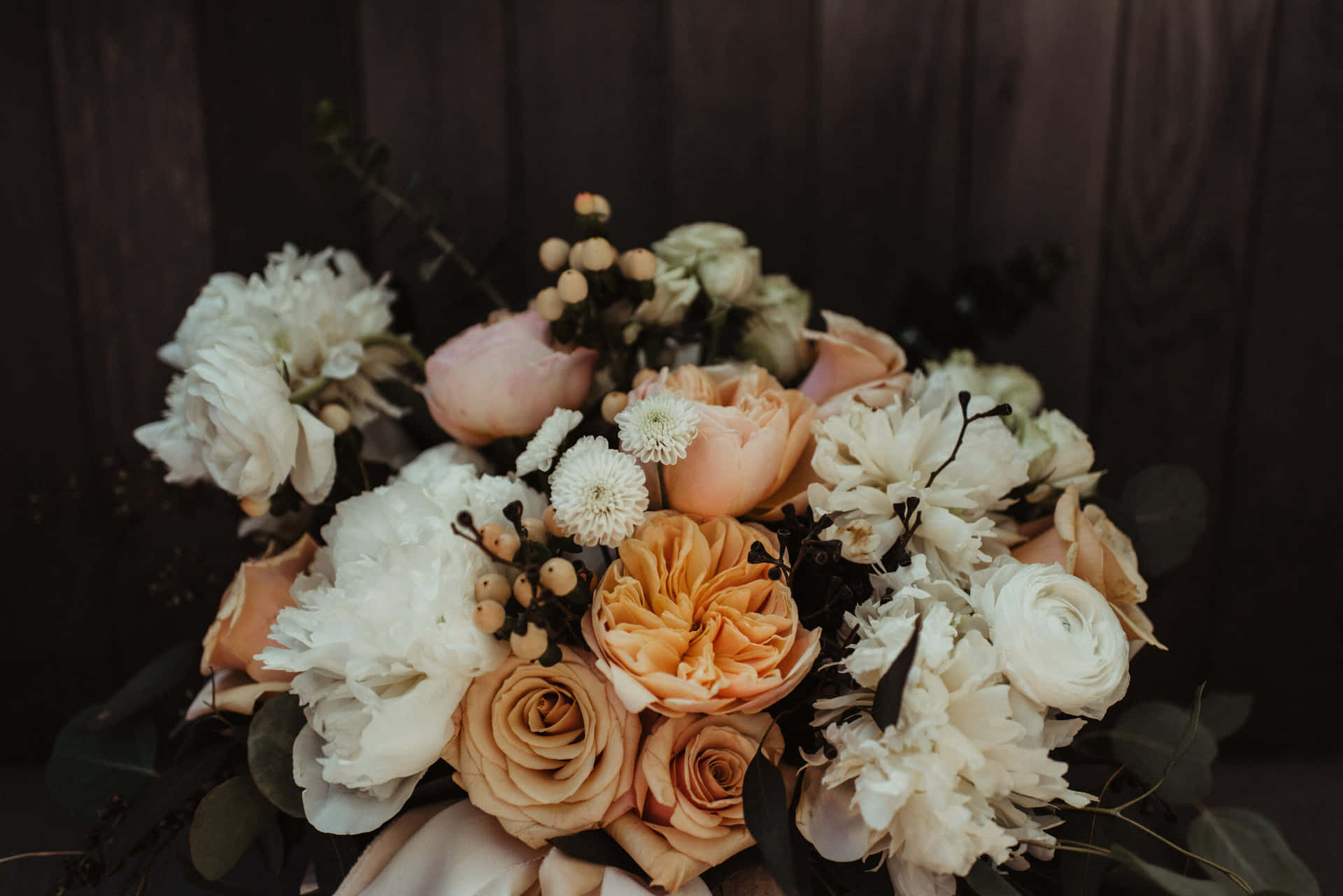 Stunning Wedding Bouquet Held by Elegant Bride Wallpaper