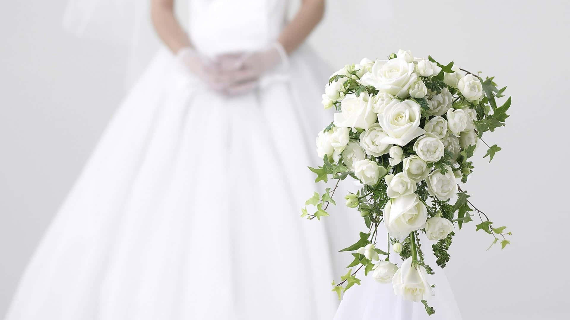 Bride Holding a Vibrant Wedding Bouquet Wallpaper
