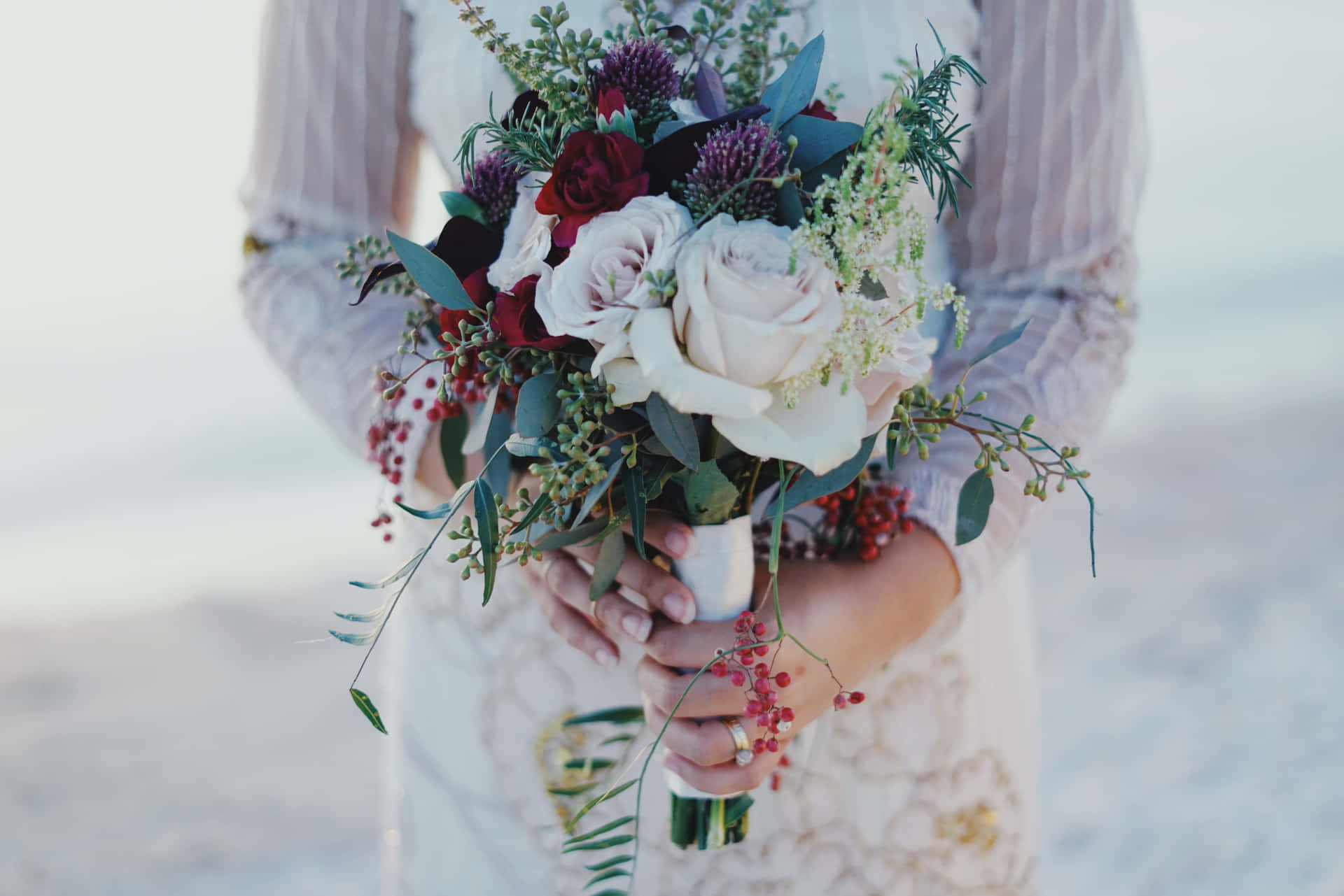 Stunning wedding bouquet in the hands of a beautiful bride Wallpaper