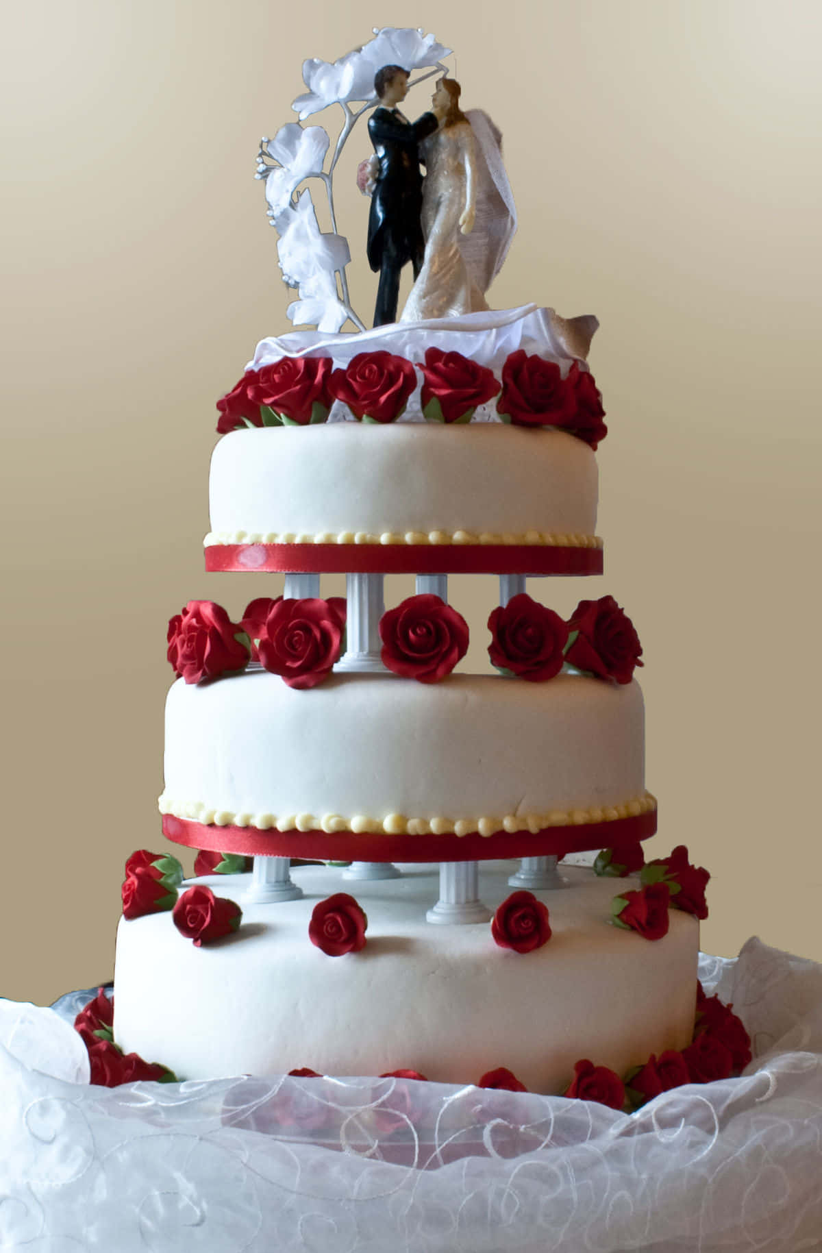 A Wedding Cake With A Couple On Top