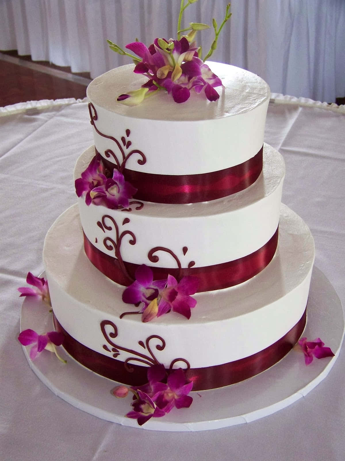 A White Cake With Purple Flowers On Top