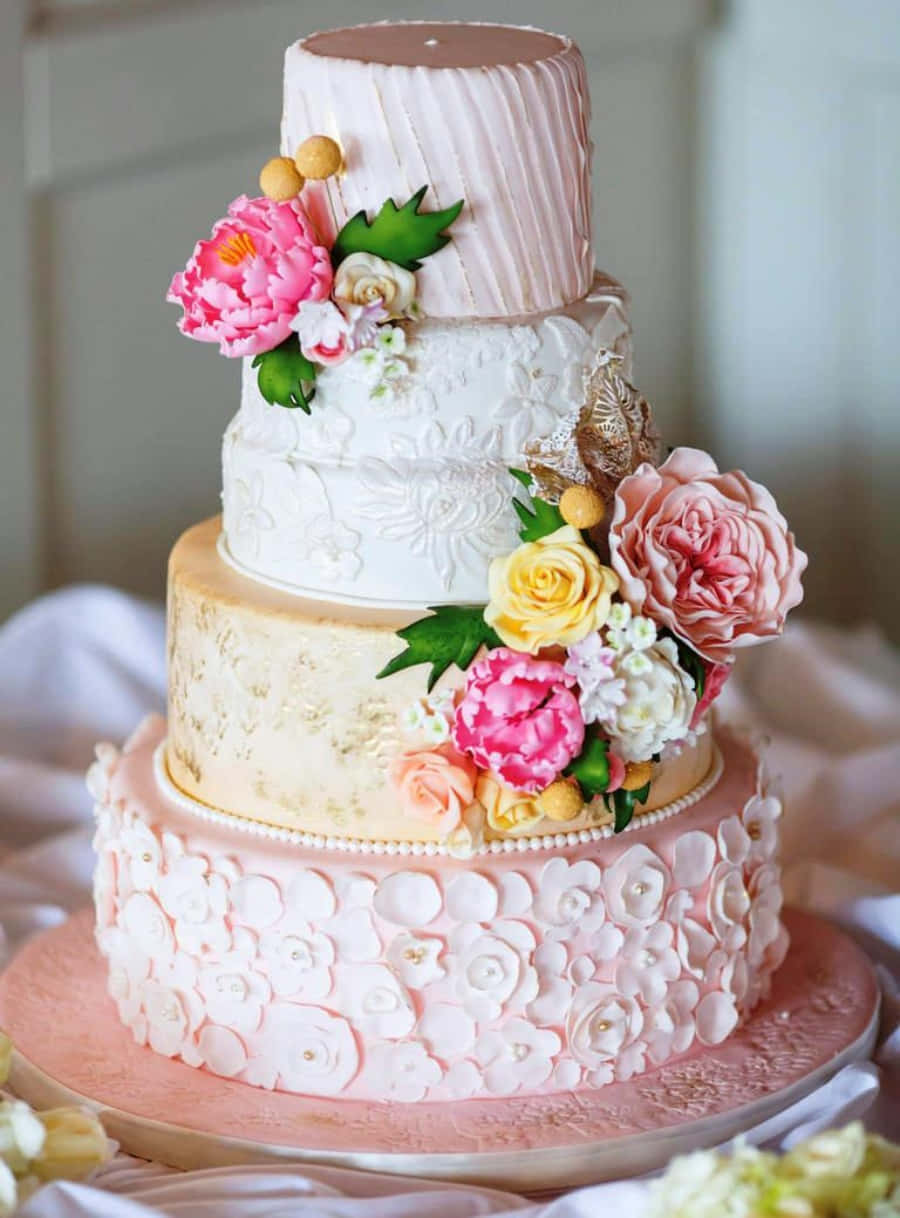 A Wedding Cake With Pink Flowers On Top