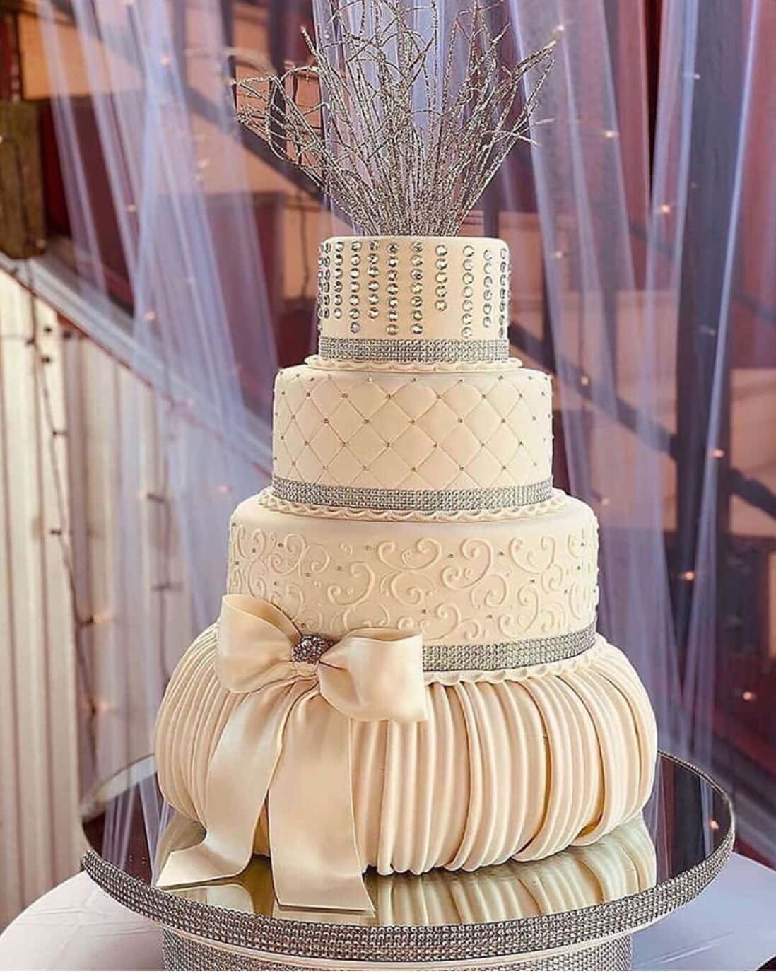 "A multi-layered Wedding Cake with a White Frosting and Fresh Flowers"
