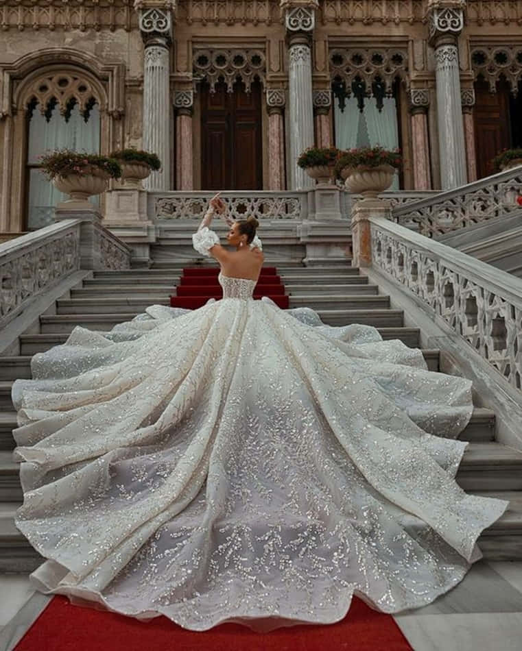 A Woman In A Wedding Dress Is Standing On The Steps Of A Building