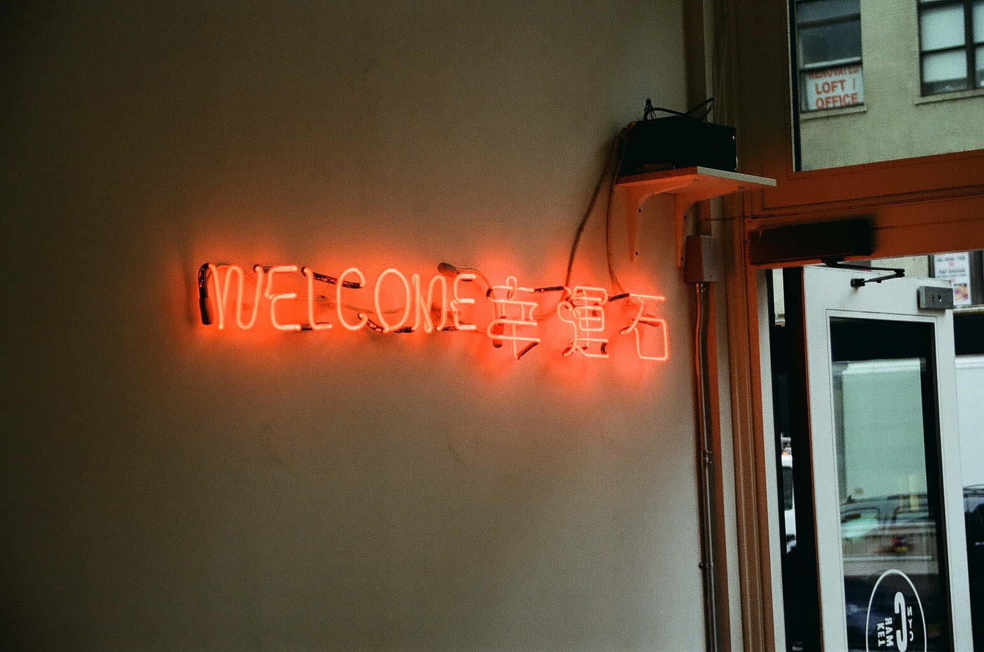 A Neon Sign That Says Welcome On A Wall