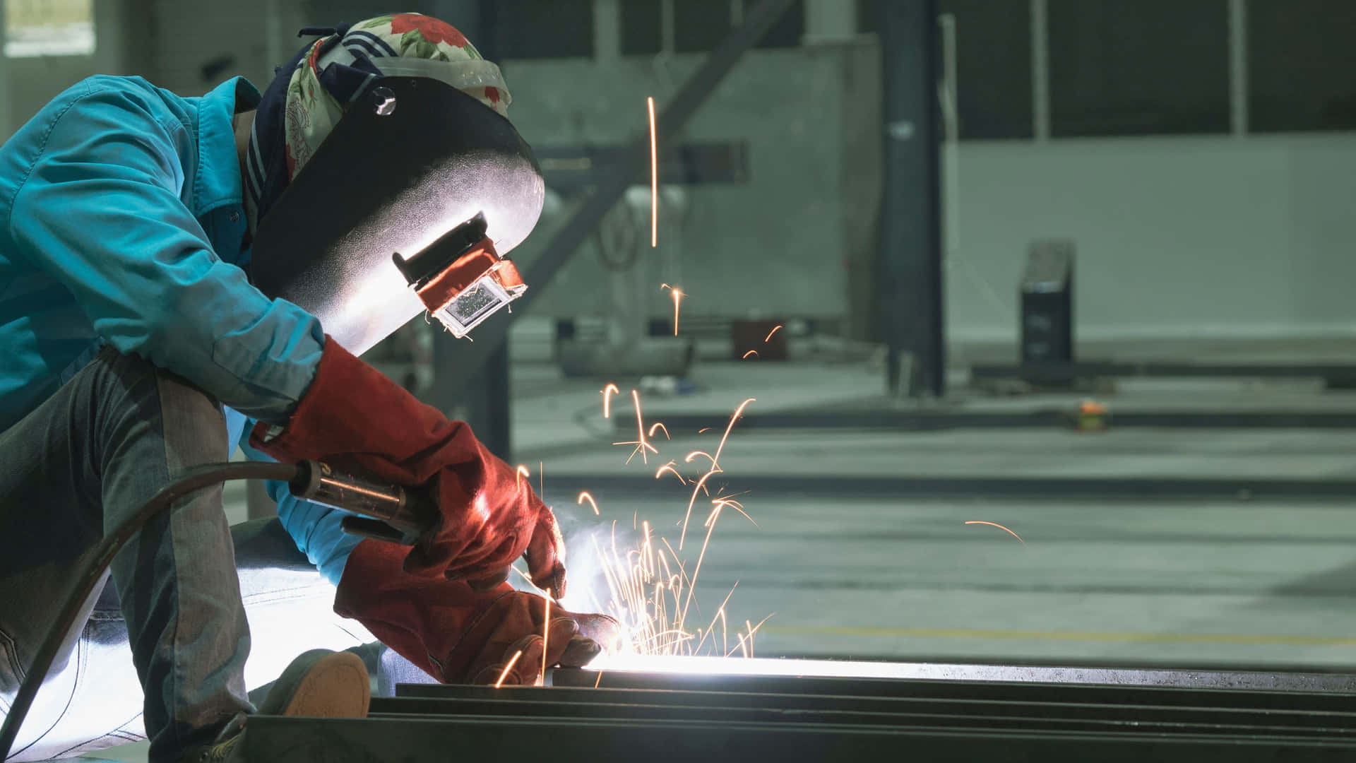 A Welder Is Welding Metal In A Factory Wallpaper