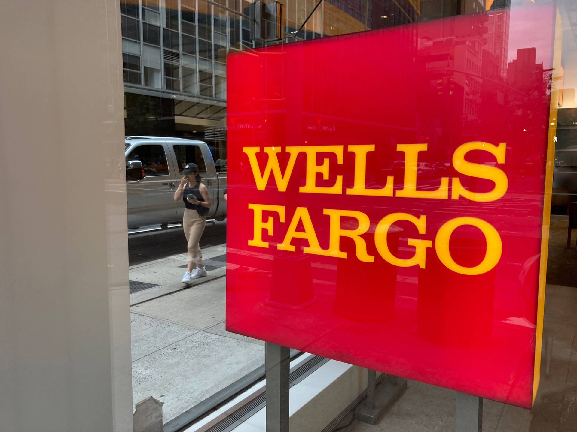Wells Fargo Company Sign Behind a Glass wall Wallpaper
