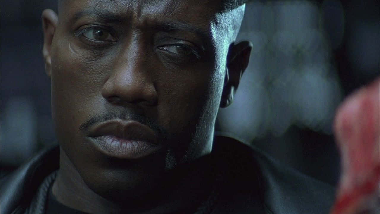Wesley Snipes striking a pose in a stylish outfit Wallpaper
