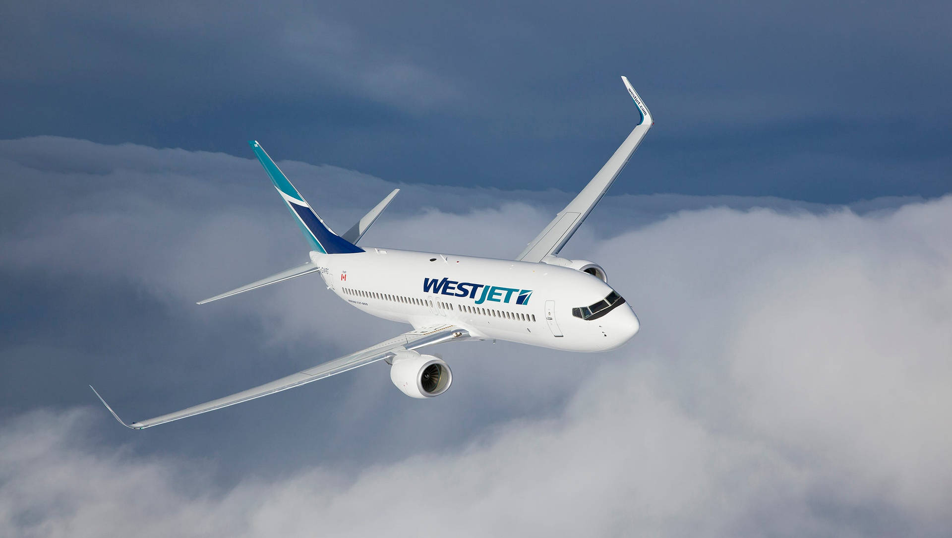 Westjet Airplane Gliding Over Cloudy Sky Wallpaper