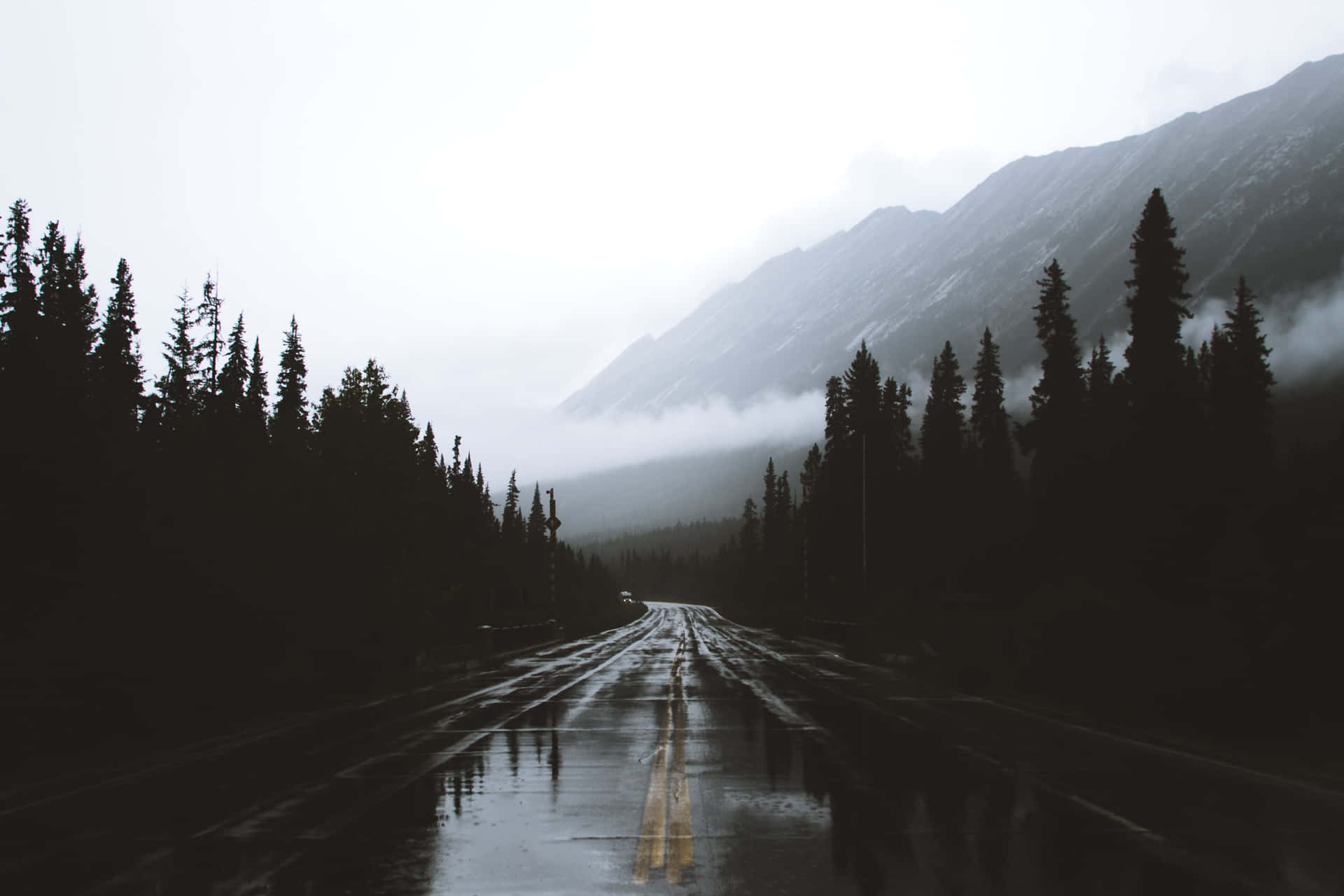 Wet Roads That Lead To Mountains Background