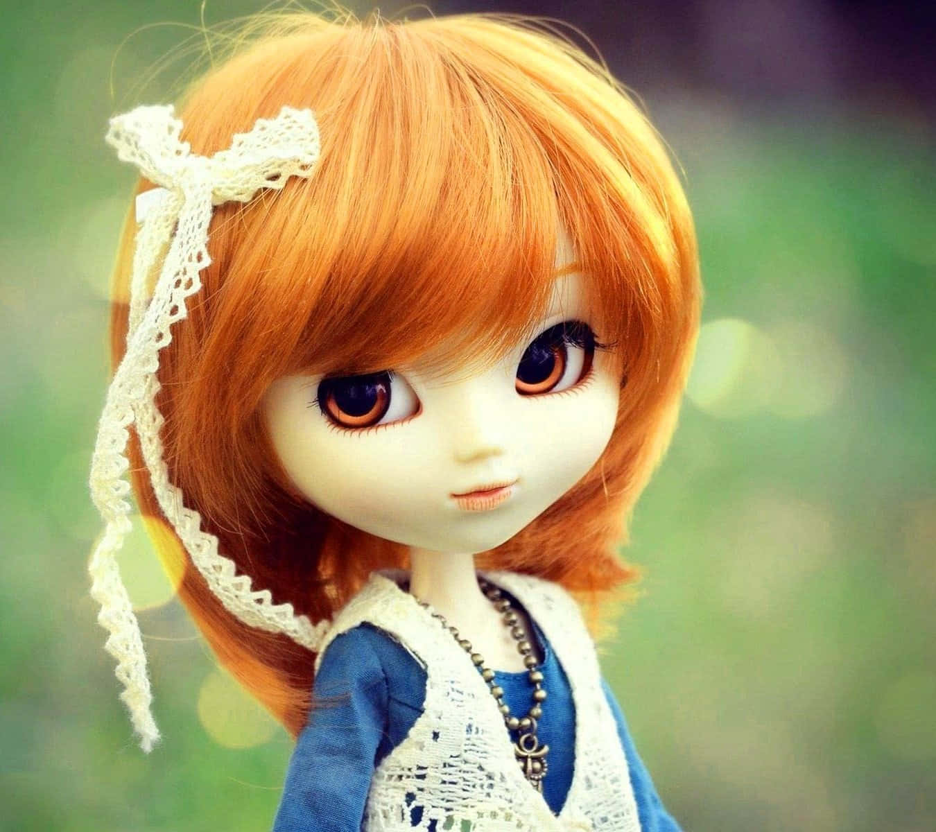 a doll with orange hair and a blue dress