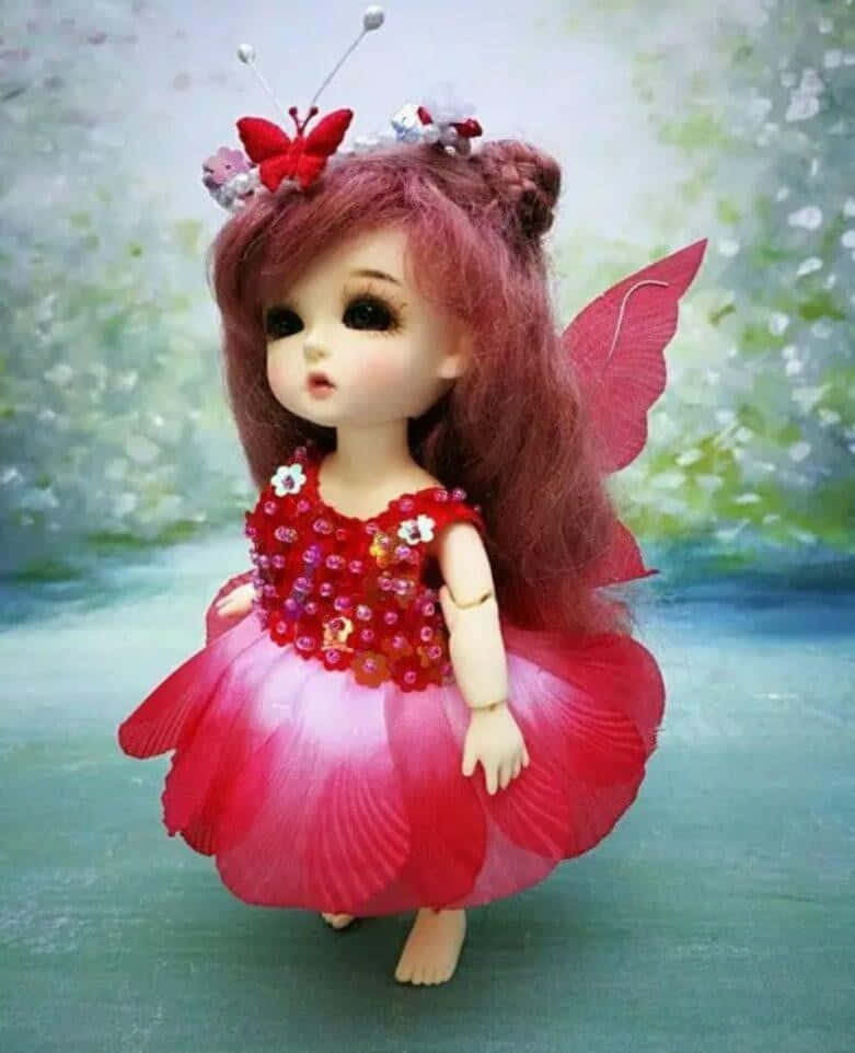 A Doll With A Red Dress And Butterfly Wings