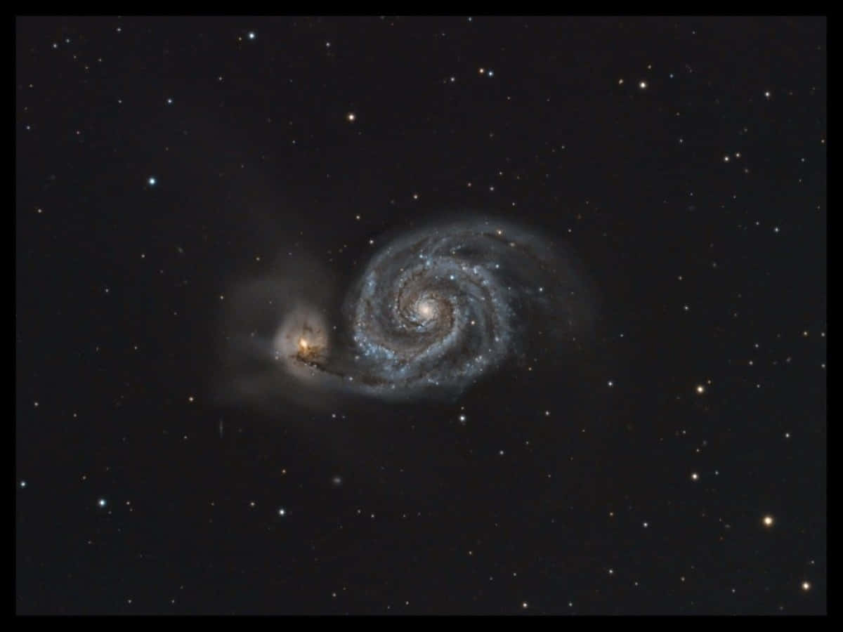 A mesmerizing view of the Whirlpool Galaxy Wallpaper