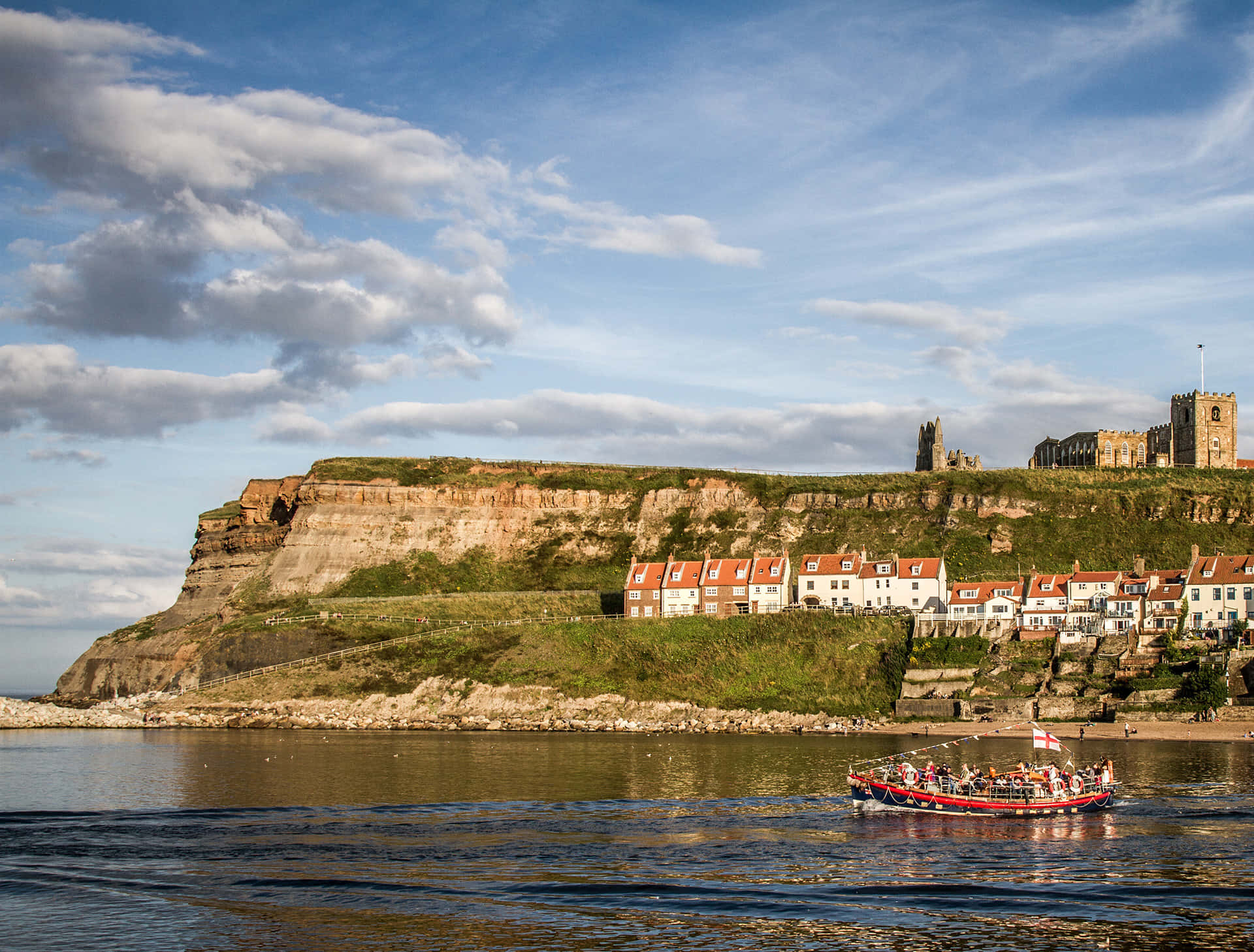 Whitby Cliffside Viewwith Boat Wallpaper