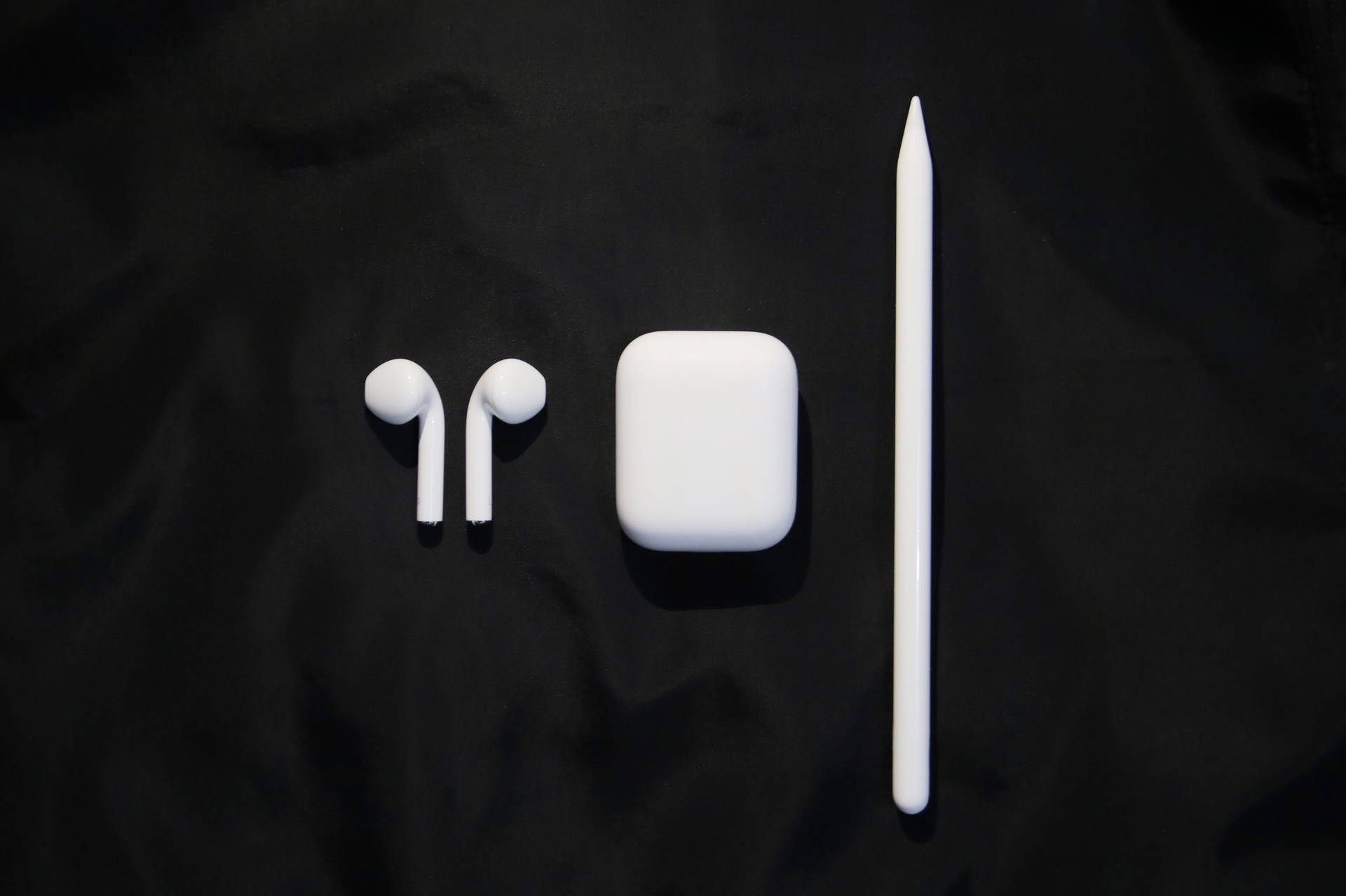 Stylish White AirPods with Accessories Wallpaper