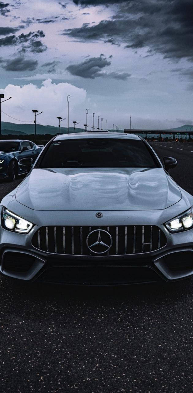 Unleashing Power - White AMG Under Mysterious Dark Sky Wallpaper