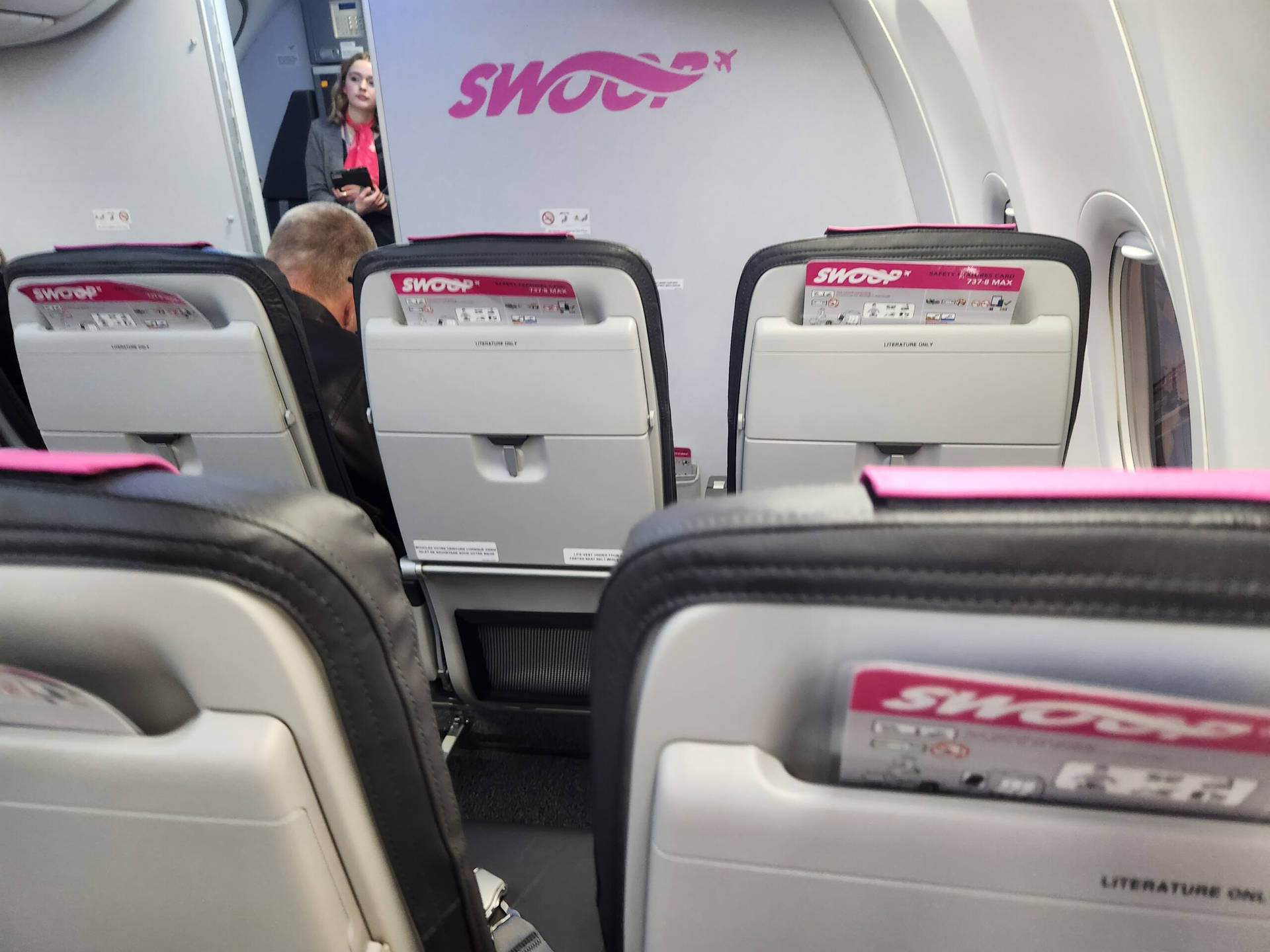 White And Pink Seats Of Swoop Aircraft Wallpaper