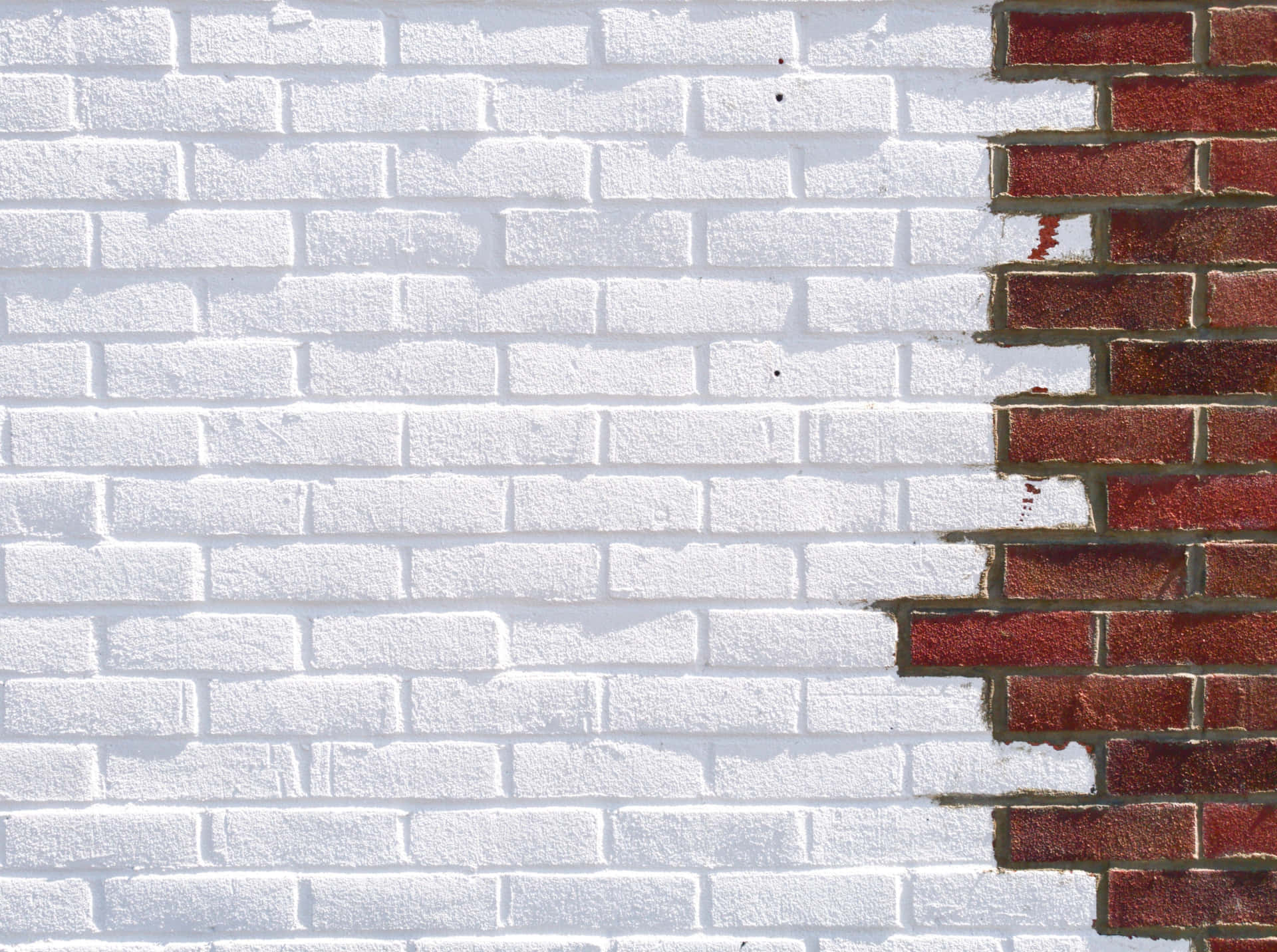 A Brick Wall With A White And Red Brick