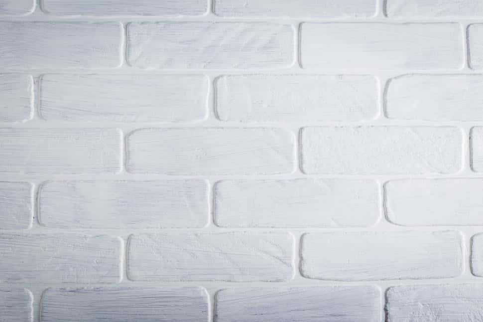 An abstract, red-tinted white brick wall background.