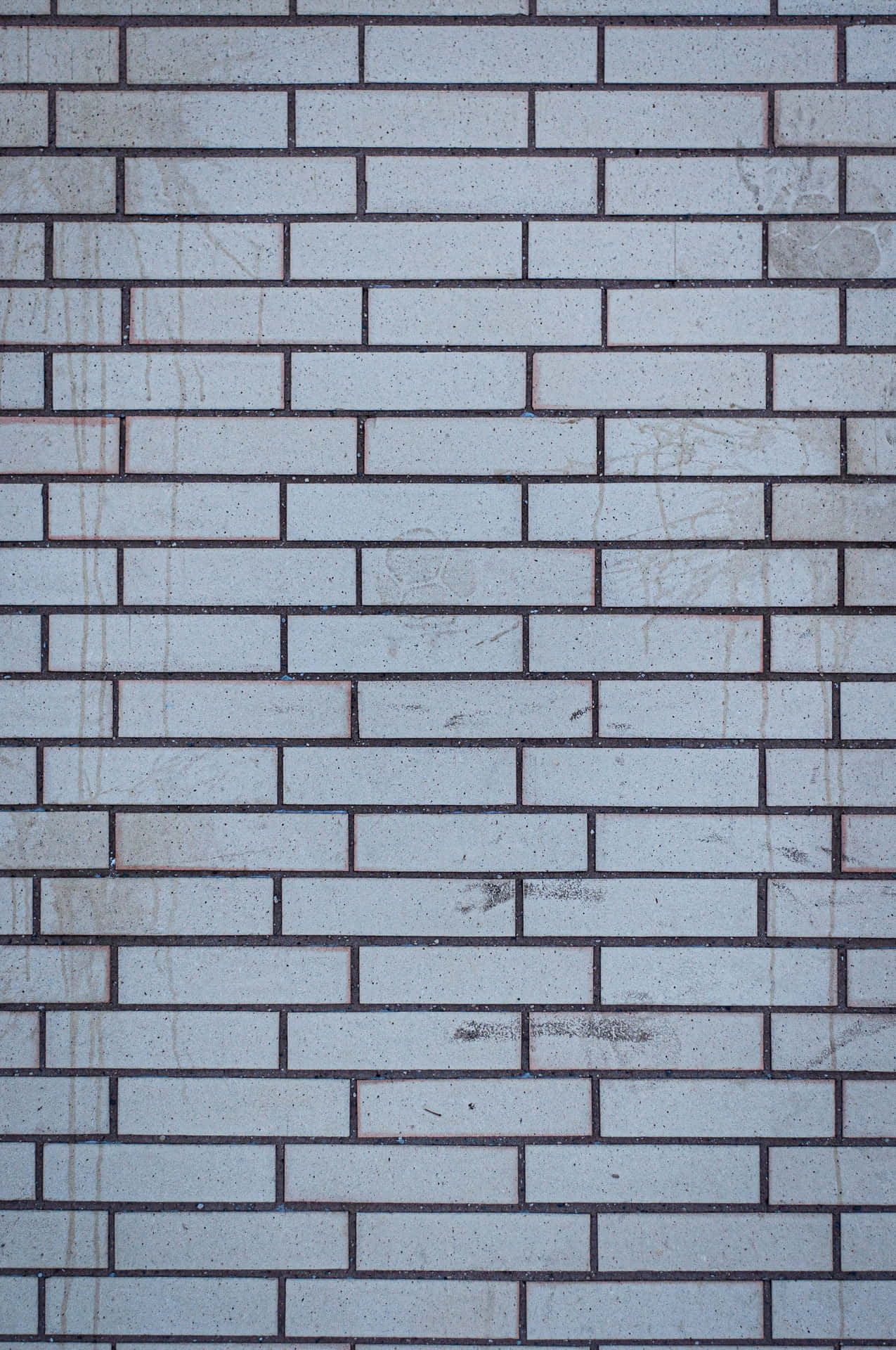 A white brick wall with texture and depth