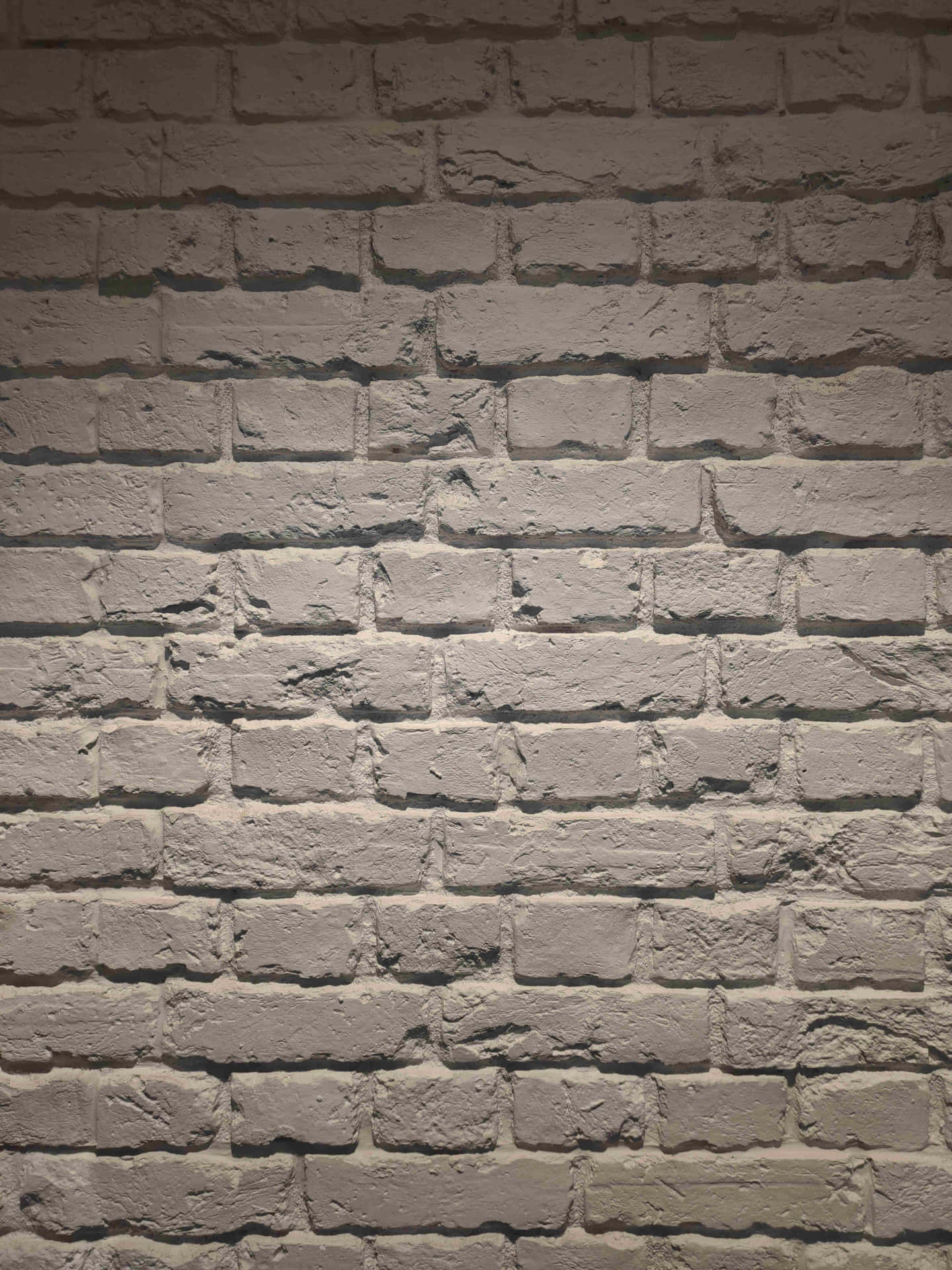 A Brick Wall With A Light On It