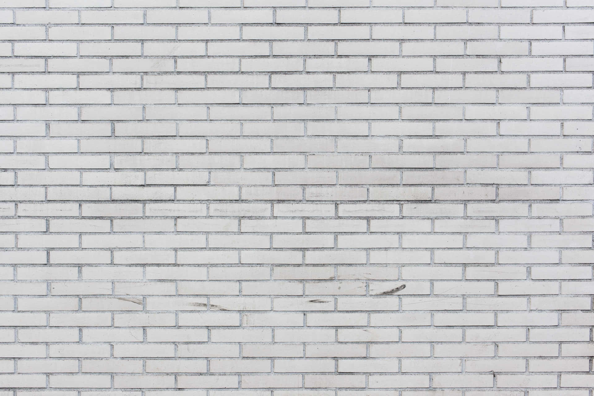 A White Brick Wall With A White Paint On It