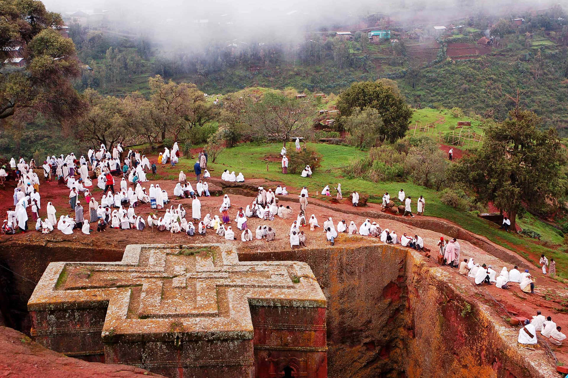 White-clothed Orthodox Christians Gather Around Lalibela's St. George Church Wallpaper