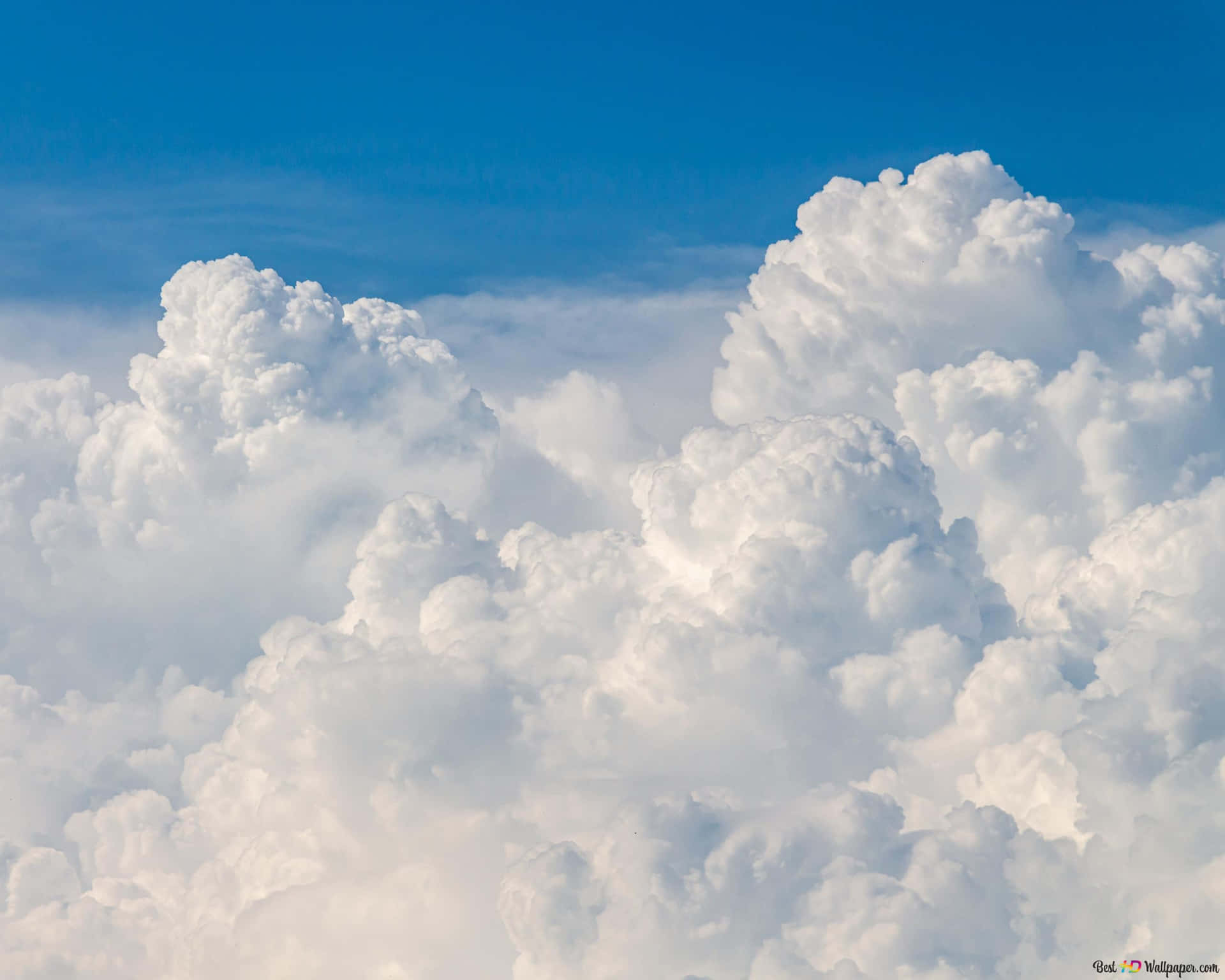 White clouds in an infinite blue sky Wallpaper