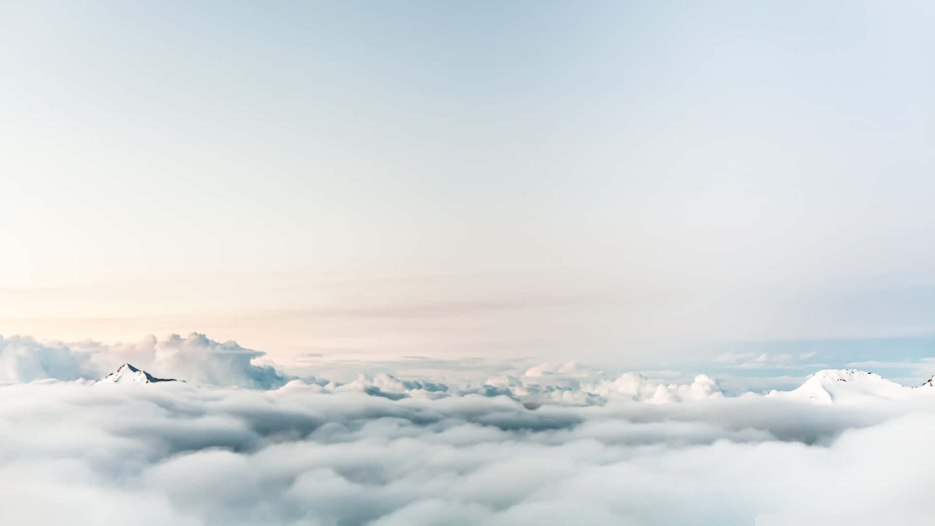 Serene View of White Clouds Flowing Against the Blue Sky Wallpaper