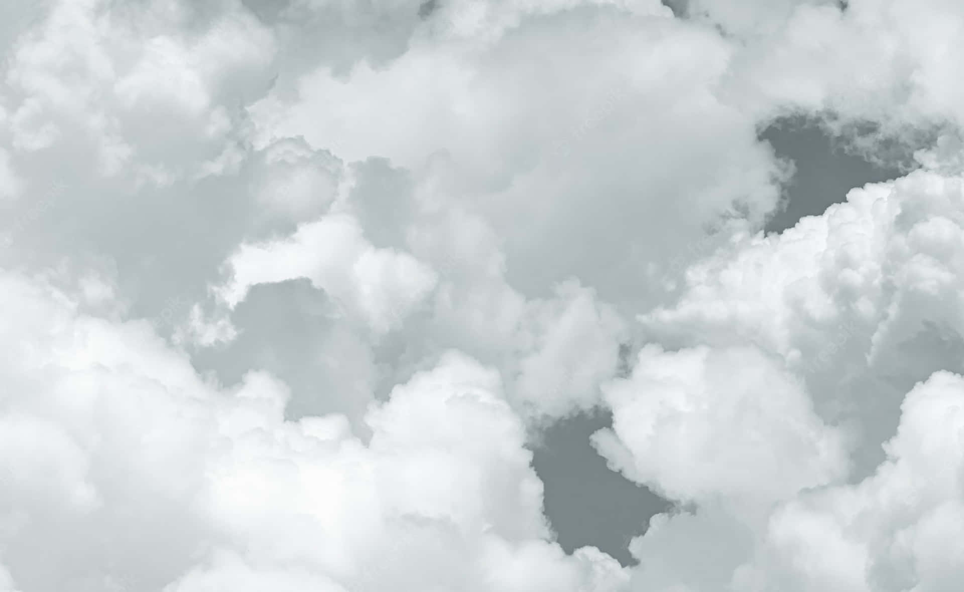Endlessly floating through the sky, white clouds stretch into the horizon Wallpaper