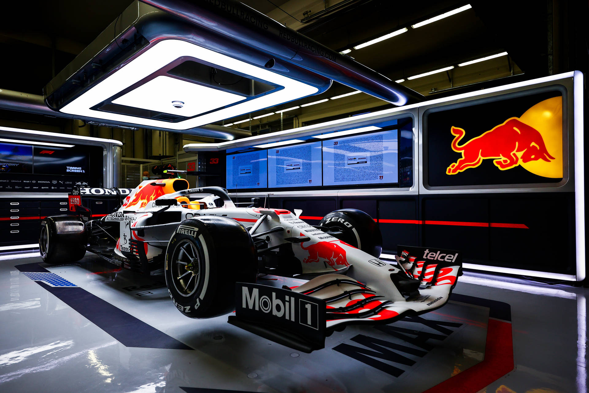 Power and Speed Personified: Red Bull F1 in Action Wallpaper