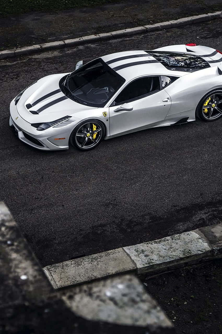 A White Ferrari Sports Car Is Parked On A Street Wallpaper
